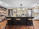 Kitchen island with bar stool seating and pendant lights, connecting to adjacent areas for seamless entertaining at 1394 N Michigan Rd, Shelbyville, IN 46176
