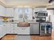 Bright kitchen with white cabinets, stainless steel appliances, granite countertops, and a unique copper farmhouse sink at 1394 N Michigan Rd, Shelbyville, IN 46176
