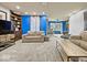 Cozy living room with plush carpeting, comfortable seating, built-in shelving, and a hanging chair by the window at 1394 N Michigan Rd, Shelbyville, IN 46176