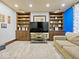 Entertainment area featuring built-in bookshelves, a modern TV, and comfortable seating, perfect for relaxation at 1394 N Michigan Rd, Shelbyville, IN 46176
