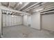 Unfinished basement, providing a blank canvas for customization, with exposed beams and painted walls at 1627 Lawton Ave, Indianapolis, IN 46203