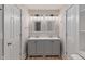 Bathroom with a gray vanity, double sinks, and square mirrors beneath modern lighting at 1627 Lawton Ave, Indianapolis, IN 46203