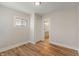 An empty bedroom with new wood flooring, bright natural light and closet and bathroom access at 1627 Lawton Ave, Indianapolis, IN 46203