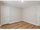 Bedroom with wood flooring, white walls, and two doors; offering flexibility in layout and design at 1627 Lawton Ave, Indianapolis, IN 46203