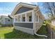 This home features gray siding, a covered porch with white accents, and a well-maintained lawn at 1627 Lawton Ave, Indianapolis, IN 46203