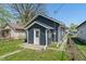 Backyard exterior view of the home featuring blue vinyl siding at 1627 Lawton Ave, Indianapolis, IN 46203