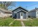 Backyard exterior view of the home featuring blue vinyl siding at 1627 Lawton Ave, Indianapolis, IN 46203