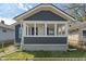 Charming exterior of home with siding, a covered porch with white accents, and the house number above the door at 1627 Lawton Ave, Indianapolis, IN 46203