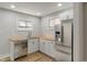 Well-lit kitchen featuring stainless steel appliances, white cabinets, and butcher block countertops at 1627 Lawton Ave, Indianapolis, IN 46203