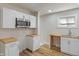 Bright kitchen with modern appliances, butcher block countertops, and fresh white cabinets at 1627 Lawton Ave, Indianapolis, IN 46203