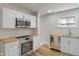 Bright kitchen with stainless steel appliances, butcher block countertops, and fresh white cabinets at 1627 Lawton Ave, Indianapolis, IN 46203