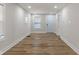 Bright living room featuring newly installed floors, fresh white paint, a new front door, and windows at 1627 Lawton Ave, Indianapolis, IN 46203