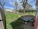 Spacious backyard with a mix of green grass, a small brick patio, and partial fence at 1824 Spann Ave, Indianapolis, IN 46203