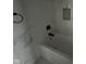 Bathroom featuring tiled walls, modern tub, and contemporary black fixtures at 1824 Spann Ave, Indianapolis, IN 46203