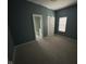 Bedroom featuring soft gray carpet, neutral gray walls, white door and windows at 1824 Spann Ave, Indianapolis, IN 46203