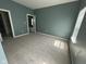 Bedroom featuring soft gray carpet, neutral gray walls, and natural light from window at 1824 Spann Ave, Indianapolis, IN 46203