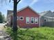 The side view of a cozy one-story home with a simple yard and view of the neighbor's house at 1824 Spann Ave, Indianapolis, IN 46203