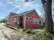 View of the home's side with a small back patio and entrance with a wooden step at 1824 Spann Ave, Indianapolis, IN 46203