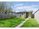 View of backyard with a well-kept lawn and convenient access to the back of the house at 1835 N Rural St, Indianapolis, IN 46218