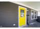 Bright yellow front door with glass, set against gray siding and white trim at 1835 N Rural St, Indianapolis, IN 46218