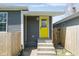 Charming exterior featuring a bright yellow front door and a tidy front porch entrance at 1835 N Rural St, Indianapolis, IN 46218