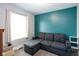 Relaxing living room showing a gray sofa with an accent wall and a window at 1835 N Rural St, Indianapolis, IN 46218