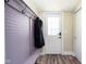 Hallway displaying a cute purple wall organizer, coat rack, and an inviting front door with window at 1835 N Rural St, Indianapolis, IN 46218