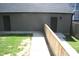 View of backyard access doors with walkway and partial wooden fence on sunny day at 1907 N Alabama St, Indianapolis, IN 46202
