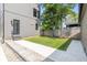 View of backyard with lush grass, concrete walkway, and a modern exterior home at 1907 N Alabama St, Indianapolis, IN 46202