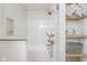 Beautifully tiled bathroom with a glass enclosed shower and tub alongside a wooden shelved nook at 1907 N Alabama St, Indianapolis, IN 46202