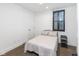 Cozy bedroom with natural light, dark window frames, and a side table at 1907 N Alabama St, Indianapolis, IN 46202