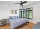 Well-lit bedroom with wood floors, decorative paintings and a modern ceiling fan at 1907 N Alabama St, Indianapolis, IN 46202