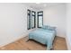 Bright bedroom featuring sleek modern windows with black shutters and light blue bedding at 1907 N Alabama St, Indianapolis, IN 46202