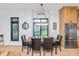 The dining area features light hardwood floors, a table, and a view of the outside at 1907 N Alabama St, Indianapolis, IN 46202