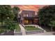 Stunning brick two-story home showcasing a covered porch, manicured lawn and professional landscaping at 1907 N Alabama St, Indianapolis, IN 46202