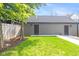 Backyard view of a detached two-car garage with a grassy lawn and mature trees at 1907 N Alabama St, Indianapolis, IN 46202