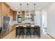 This open kitchen offers a stylish island with seating, light wood cabinets, and modern appliances at 1907 N Alabama St, Indianapolis, IN 46202