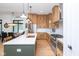 This open eat-in kitchen offers an island with a sink, stainless steel appliances, and custom cabinets at 1907 N Alabama St, Indianapolis, IN 46202