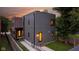 Contemporary home's backyard with a gray paneled exterior and well-kept lawn, blending modern design and nature at 1907 N Alabama St, Indianapolis, IN 46202