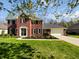 Charming red brick two-story home with a well-manicured lawn and black shutters at 2080 Norwich Pl, Martinsville, IN 46151