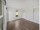 Living room with wood floors, built-in shelving, and a bright window at 2080 Norwich Pl, Martinsville, IN 46151