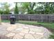 Spacious backyard with a stone patio, fire pit, and grass, perfect for outdoor relaxation and entertainment at 2120 Dakota Dr, Franklin, IN 46131