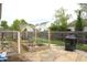 Fenced backyard featuring a garden with raised planters, a fire pit, and a stone patio at 2120 Dakota Dr, Franklin, IN 46131