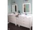 A double vanity bathroom with large mirrors and stylish lighting at 2120 Dakota Dr, Franklin, IN 46131