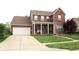 Charming two-story brick home with a well-manicured lawn and attached two car garage at 2120 Dakota Dr, Franklin, IN 46131