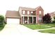 Charming two-story brick home with a well-manicured lawn and attached two car garage at 2120 Dakota Dr, Franklin, IN 46131