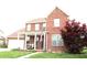 Charming two-story brick home with a cozy front porch, American flag, and lush landscaping at 2120 Dakota Dr, Franklin, IN 46131