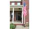 Welcoming front porch with a stylish door, decorative plants, and an American flag at 2120 Dakota Dr, Franklin, IN 46131