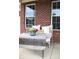 Inviting front porch with comfortable seating, decorative plants, and brick accents at 2120 Dakota Dr, Franklin, IN 46131