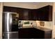 Kitchen with dark cabinetry, granite countertops, and stainless steel appliances including a modern refrigerator at 2120 Dakota Dr, Franklin, IN 46131
